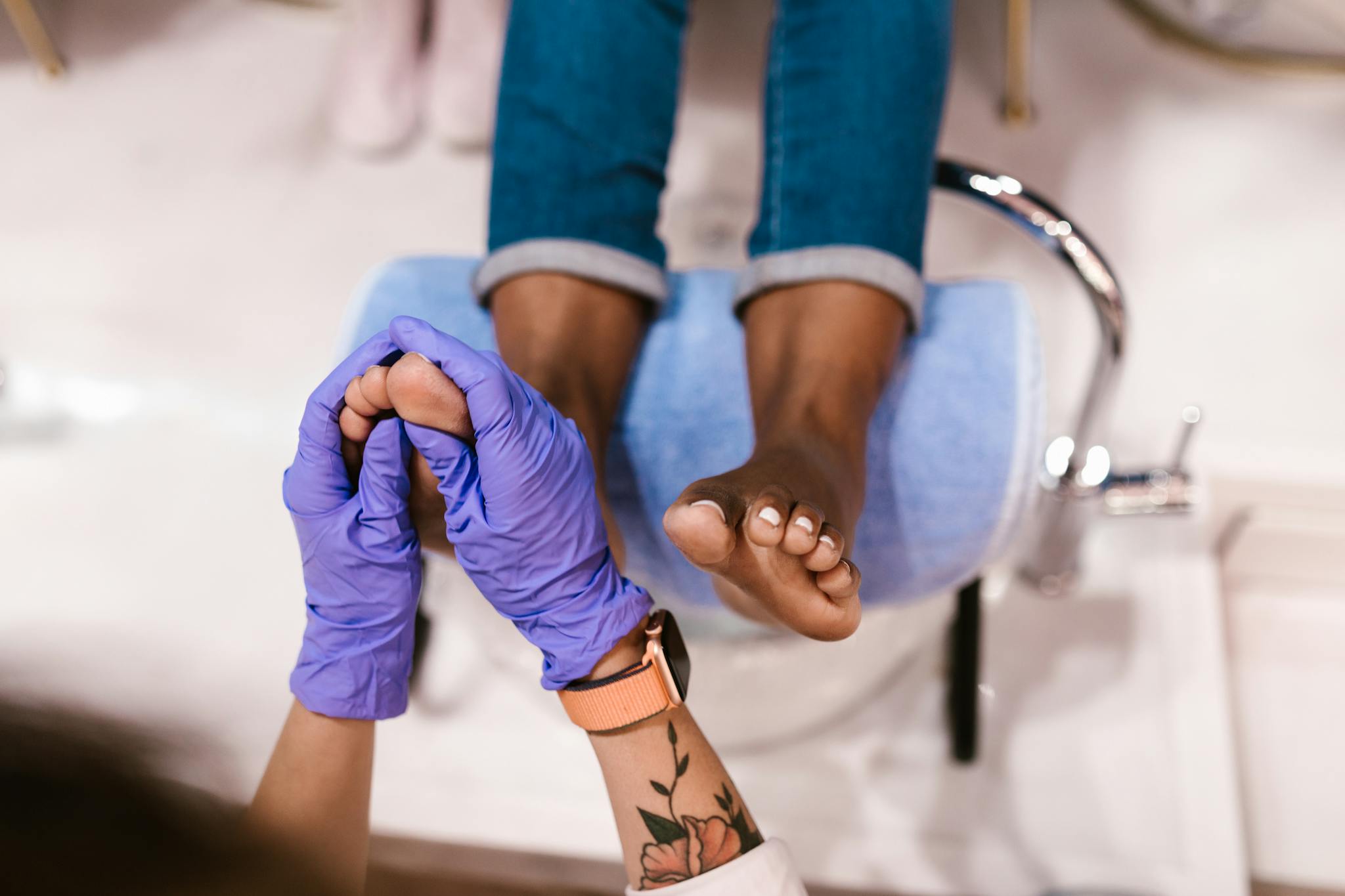 Foot massage session in a beauty salon with a focus on relaxation and pampering.